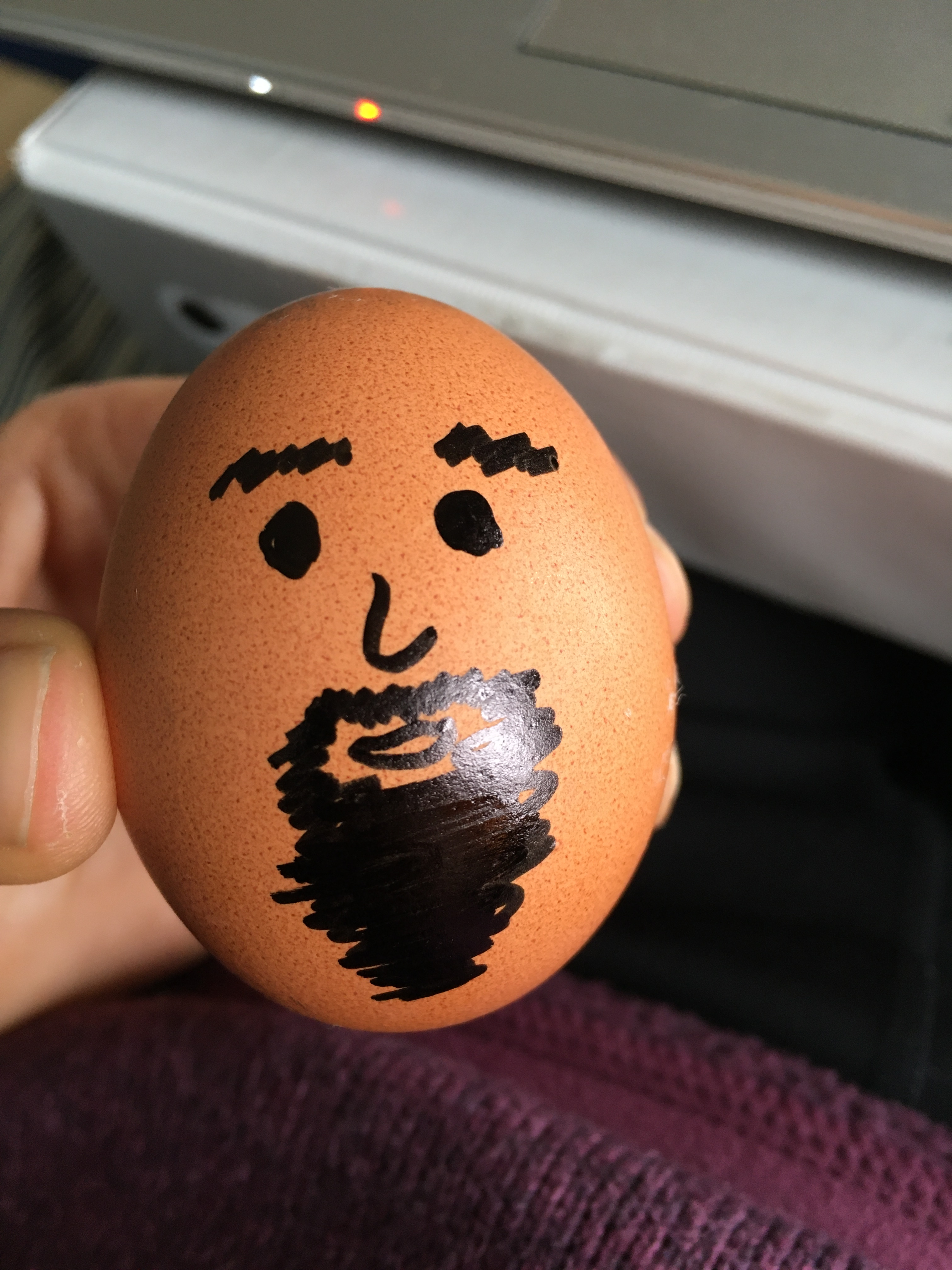 An egg with a bearded face drawn on it.