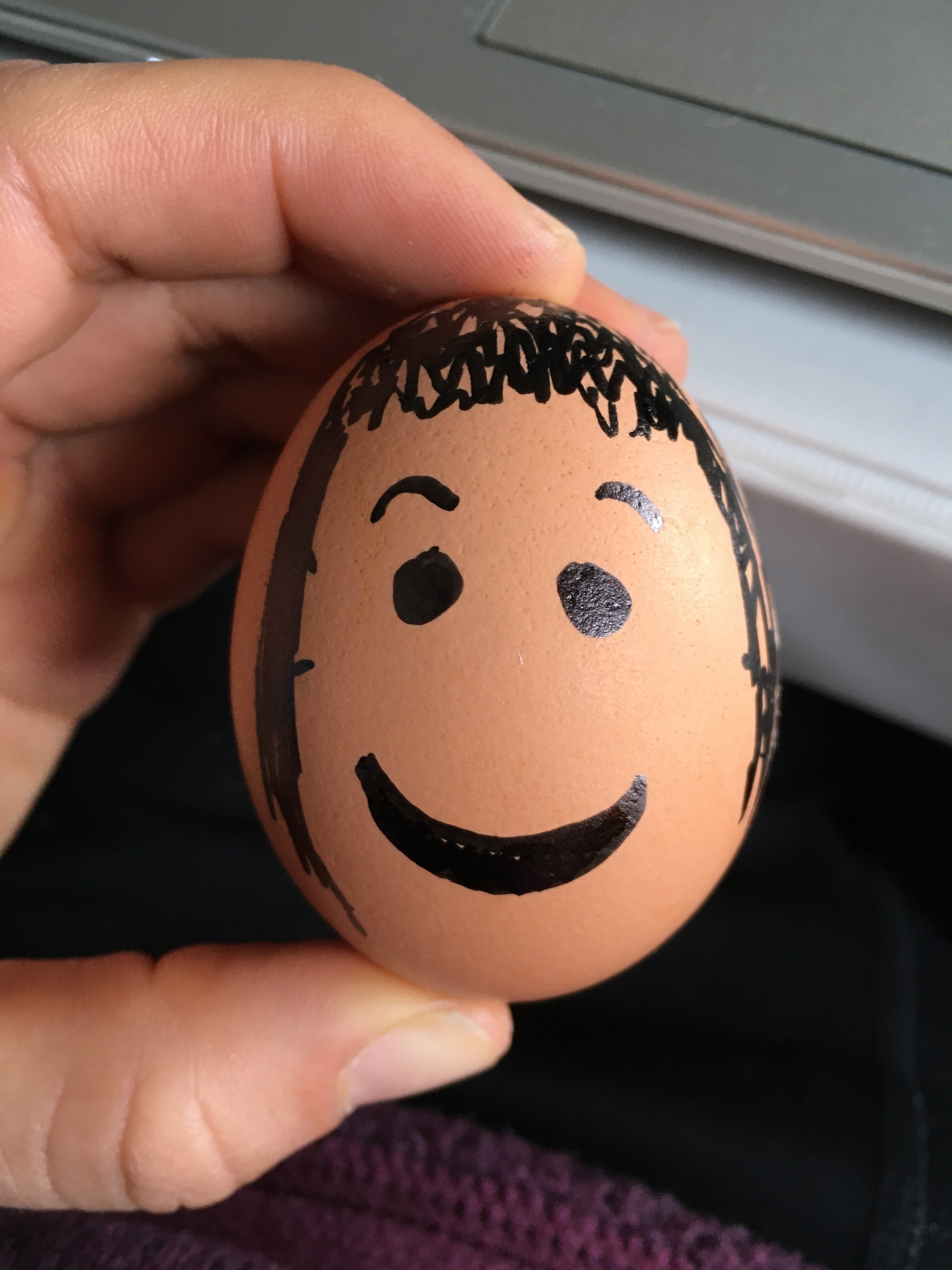 An egg with a happy face drawn on it.