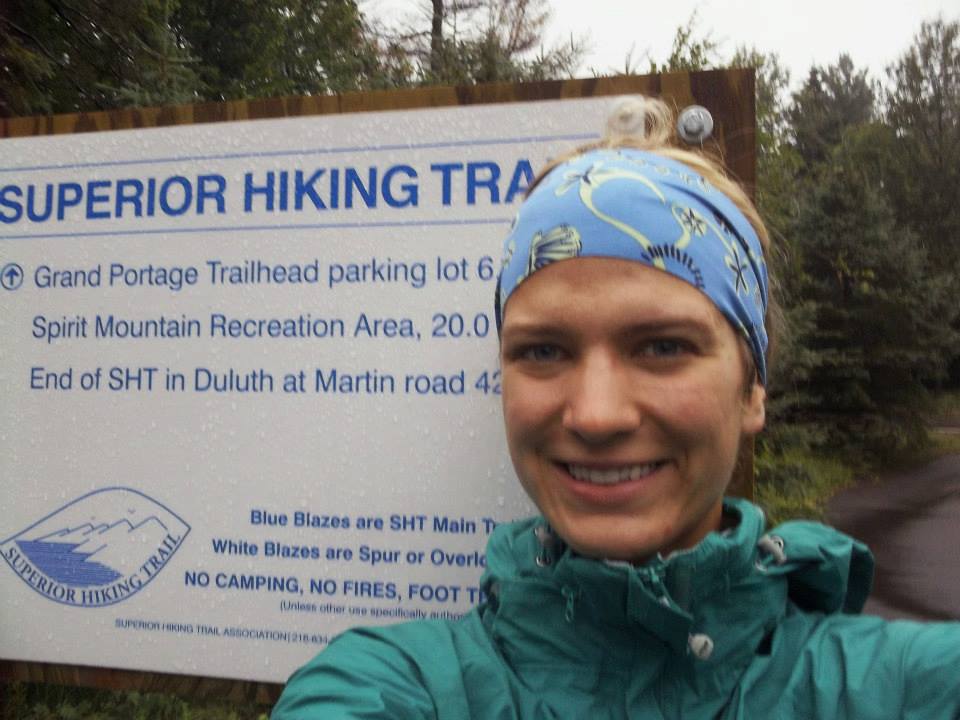Anna in front of a Superior Hiking Trail sign at the southern terminus of the trail.